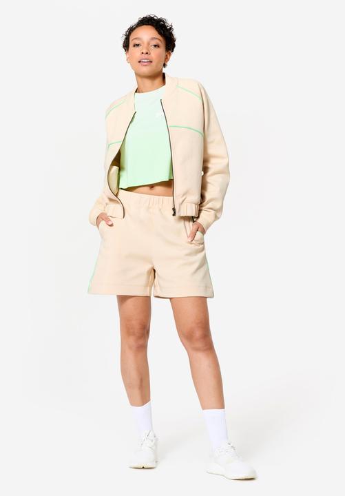 Image du produit Domyos Veste bombers zipée femme, beige avec piping vert. (XL)